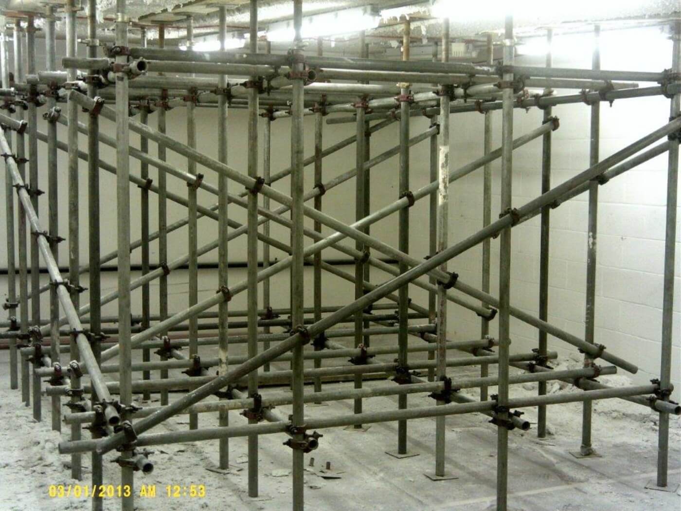 scaffolding supports a ceiling inside an industrial area